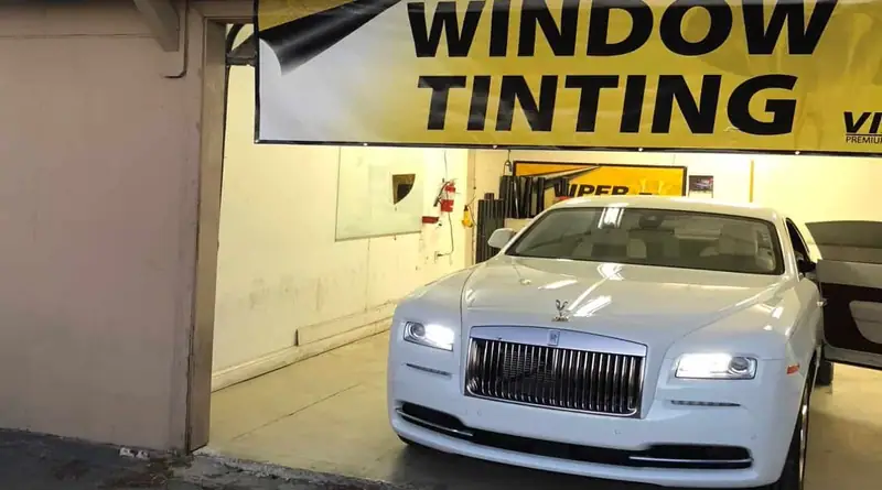White Rolls-Royce in the window tint bay