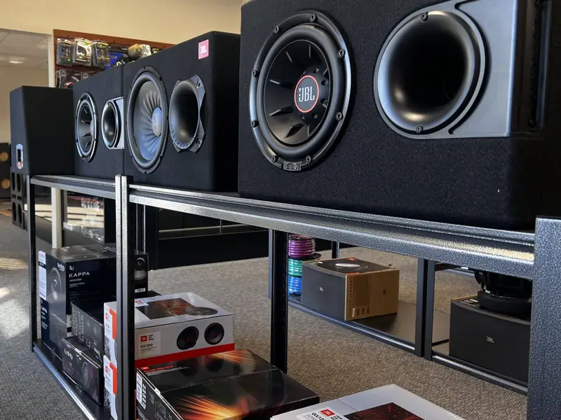 Loaded subwoofer boxes on a shelf in the shop